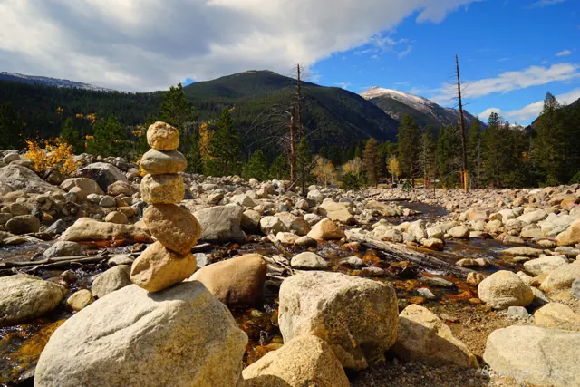 A small stone cairn on a boulder-strewn riverbed