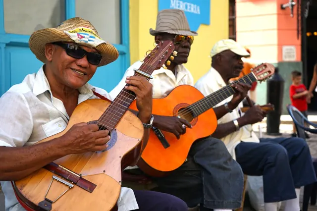 Smiling street musicians playing guitars