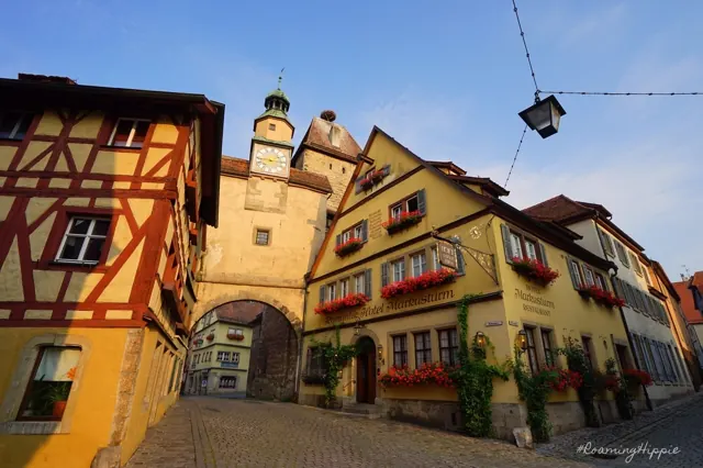 Half-timbered houses and a gate tower on a cobbled street