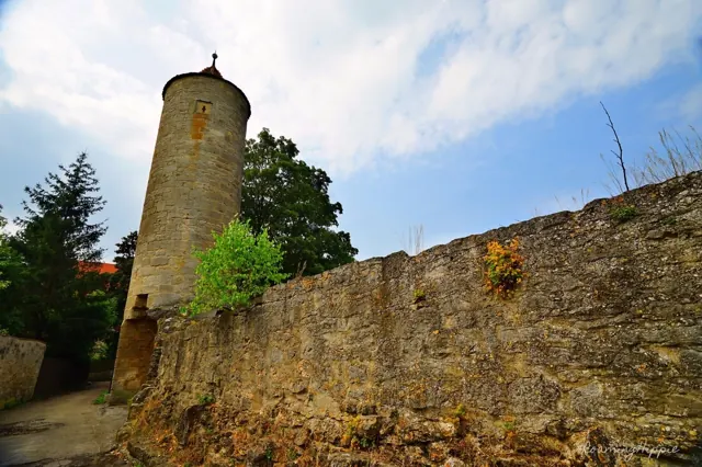 A round stone tower on an old town wall