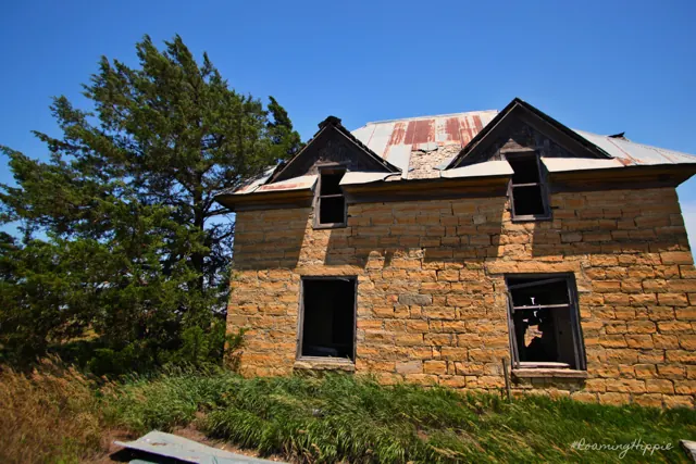 An abandoned stone farmhouse among trees