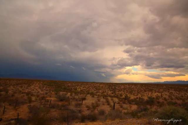 Storm clouds over flat desert grassland