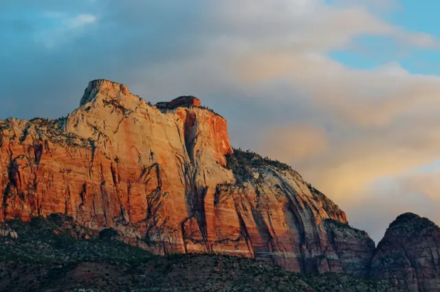A red sandstone peak lit by warm late-day light